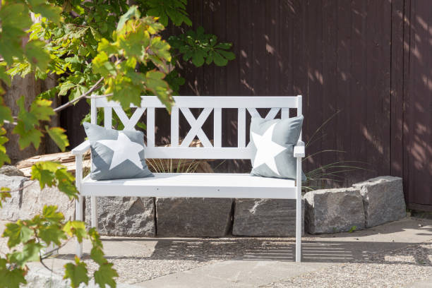 white wooden bench with cushions outdoors