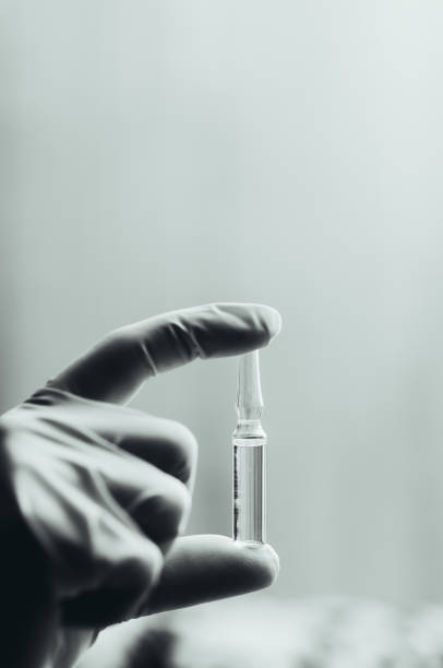 istock Ampoule in a glove on a light background 1004186674