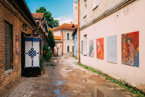 Vilnius, Lithuania - July 5, 2016: Art Objects Of Uzupis Located In Old Town Of Vilnius. Exposition Of Paintings Are On Streets Of City. District Of Vilniaus Senamiestis.