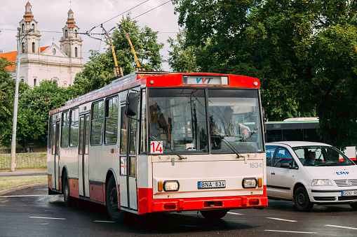 Vilnius, Lithuania  - July 5, 2016:  Old Public Trolleybus Skoda 14Tr In Summer Street And Church Of The St Raphael The Archangel On Background