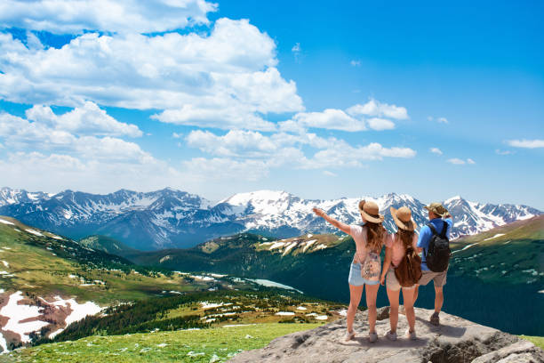 istock People standing on top of the mountain looking at beautiful view. 1004192032