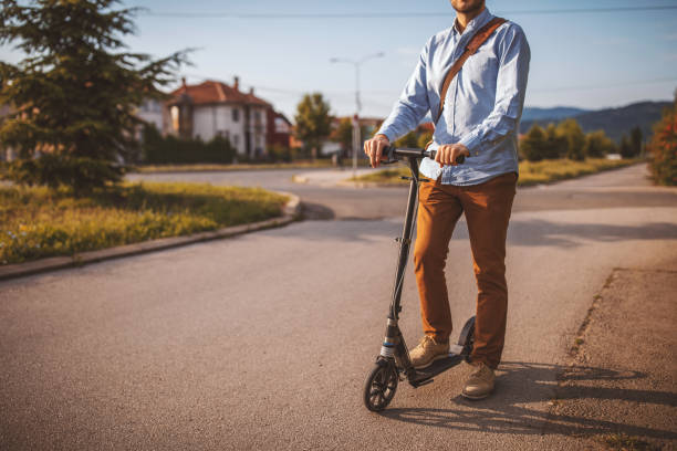 istock Businessman riding on push scooter in city 1004194510