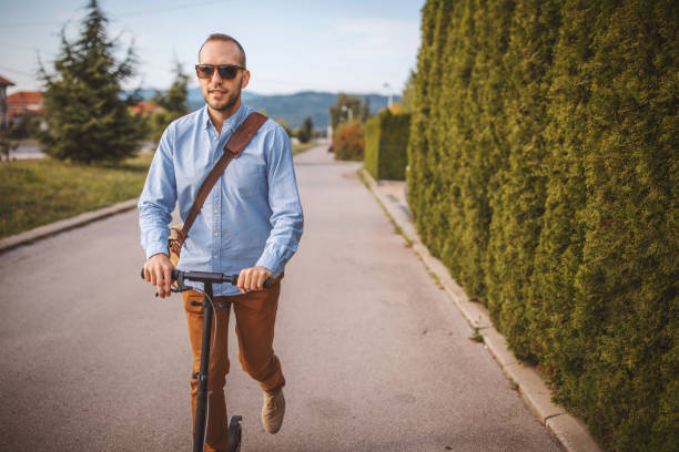 istock Young man riding push scooter in the city 1004195058