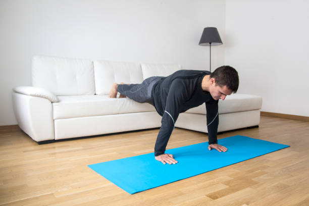 istock Young man exercising at home 1004195242
