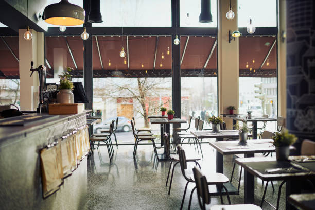 Come join us for a lunch Shot of an empty restaurant filled with tables and chairs inside during the day restaurant table layout stock pictures, royalty-free photos & images