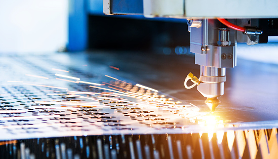 Laser cutting metal sheet with sparks flying