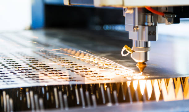 istock Laser cutting metal sheet with sparks flying 1004199150