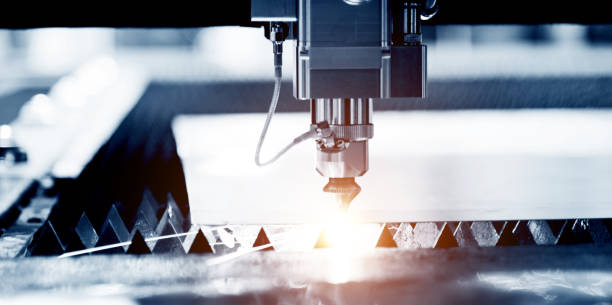 istock Laser cutting metal sheet with sparks flying 1004199254