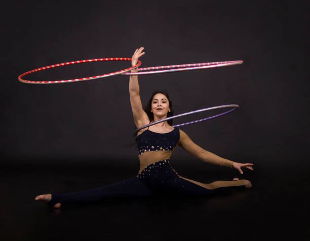 istock Gymnastic exercises with hula-Hoop girl performs circus performer in an artistic costume. 1004201556