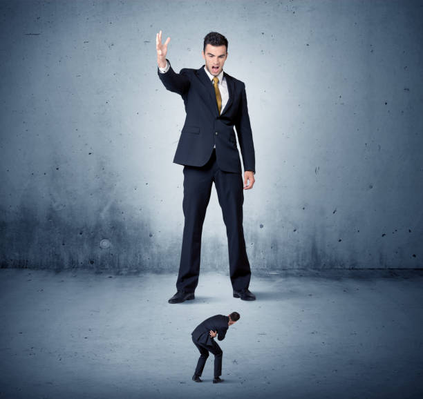 istock Angry huge business man lokking at small guy 1004201676
