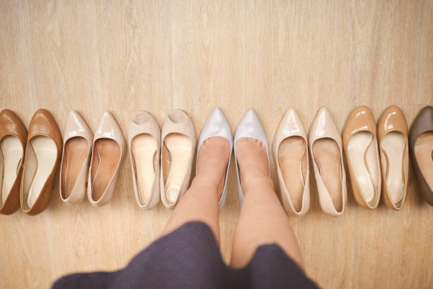 Accessories, female hand, shoes and flower on white background, top view