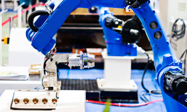 istock Robot arm working in a factory 1004205226