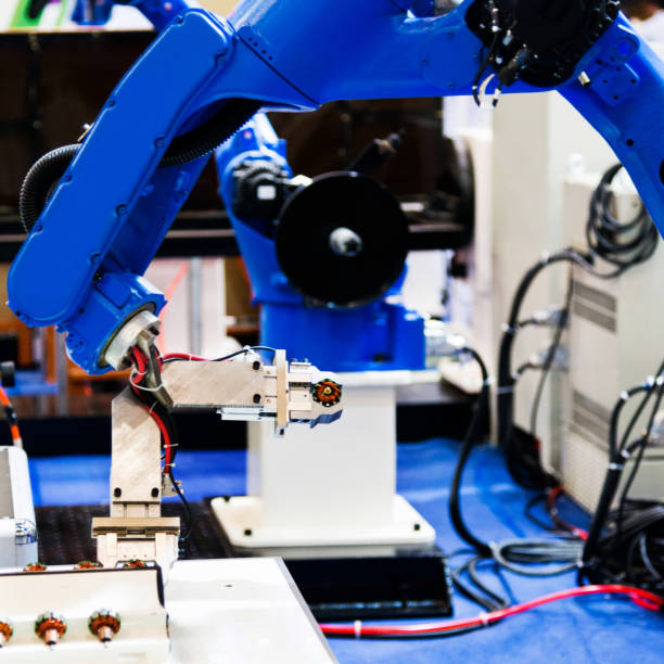 istock Robot arm working in a factory 1004205374