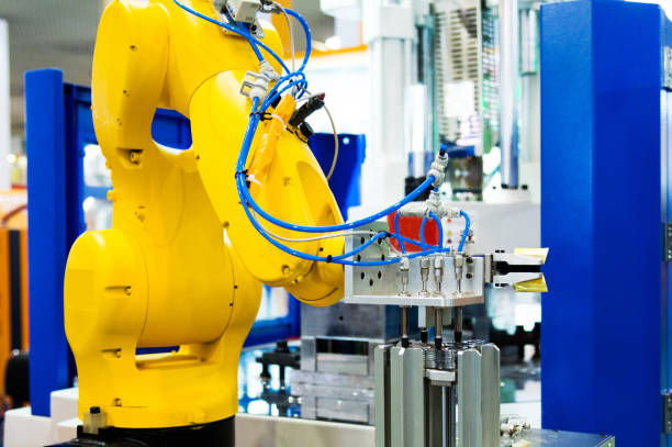 istock Robot arm working in a factory 1004205380
