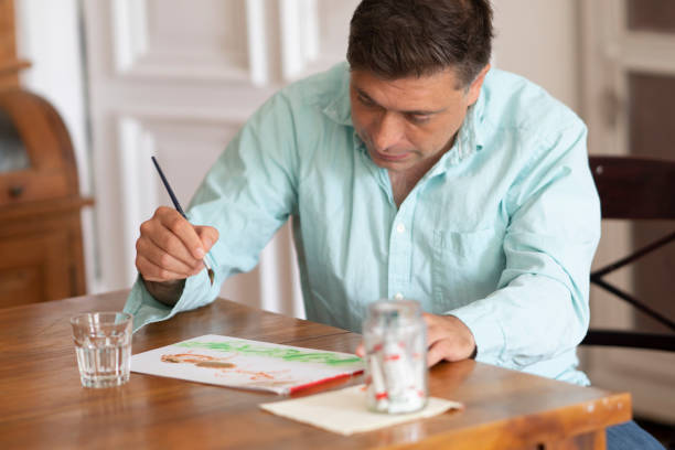 istock Man painting with brush 1004205524