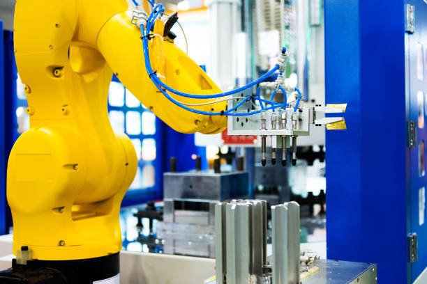 istock Robot arm working in a factory 1004205538