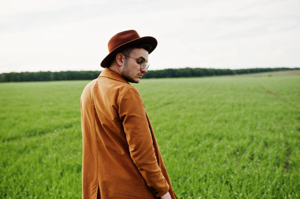 istock Stylish man in glasses, brown jacket and hat 1004205730