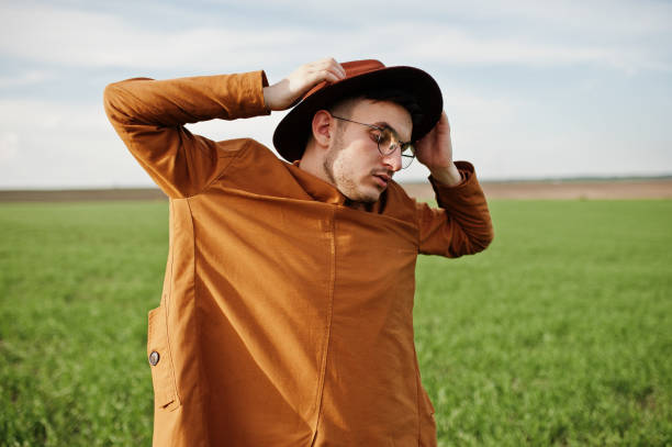 istock Stylish man in glasses, brown jacket and hat 1004206230