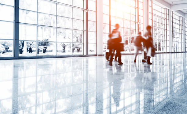 istock Motion blurred people walking in modern office 1004208858