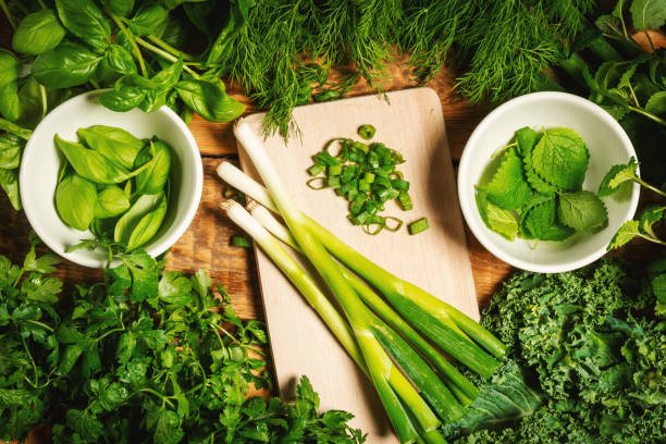 istock background with green vegetables and spices on a wooden table 1004209874