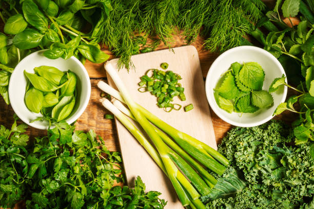istock background with green vegetables and spices on a wooden table 1004209934