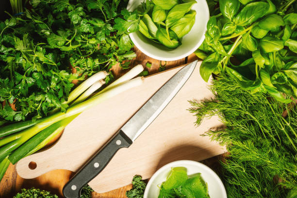 istock green vegetables and spices on a wooden table with a knife 1004210034