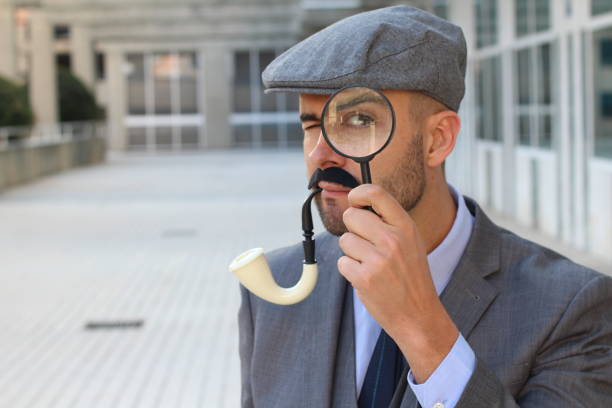 Concept image of investigation or private detective. Fedora hat, magnifing glass and vintage items over wooden table