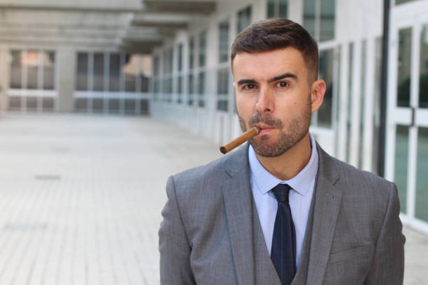 istock Businessman smoking a cigar in office space 1004212866
