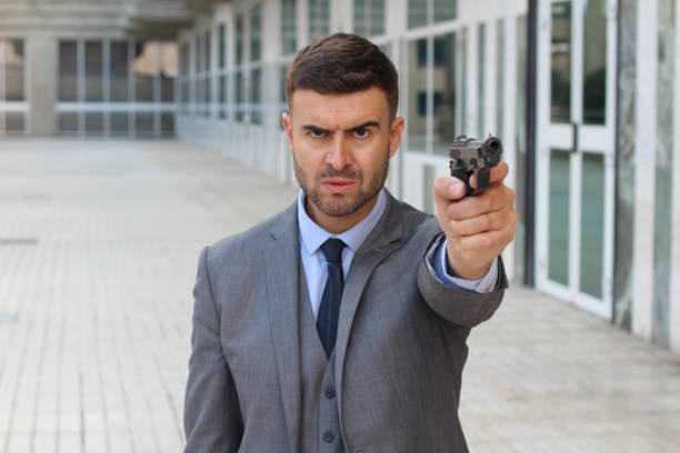 istock Elegant angry man holding gun 1004213114