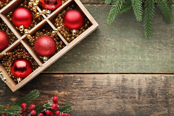 istock Red christmas baubles in crate with fir-tree branches 1004213674