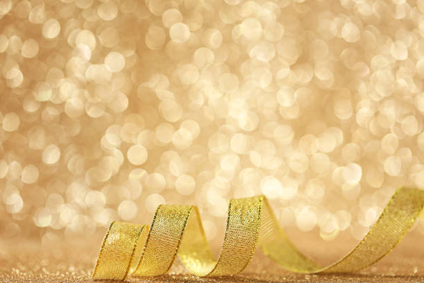 istock Golden ribbon on lights background 1004213772