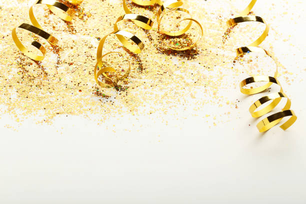 istock Golden ribbons with confetti on white background 1004216674