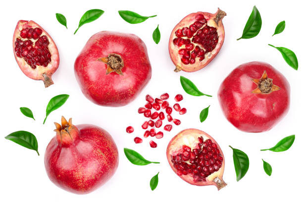 istock pomegranate with leaves isolated on white background. Top view. Flat lay pattern 1004216958