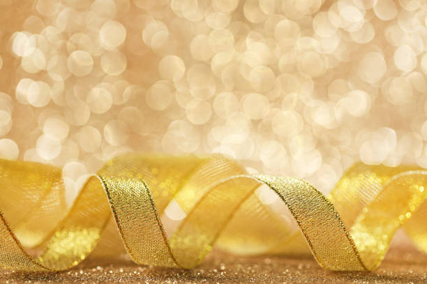 istock Golden ribbon on lights background 1004220836