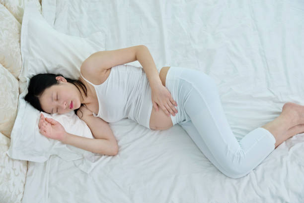 istock Pregnant woman sleeping in bed 1004221108