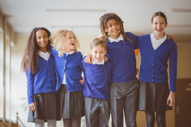 istock School kids standing together in corridor 1004222286