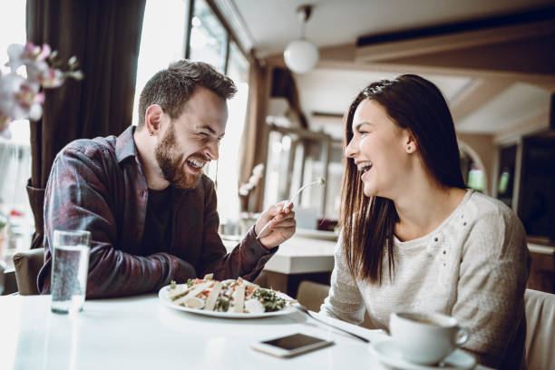 istock Boyfriend Feeding Girlfriend With Caesar Salad In Restaurant 1004226168