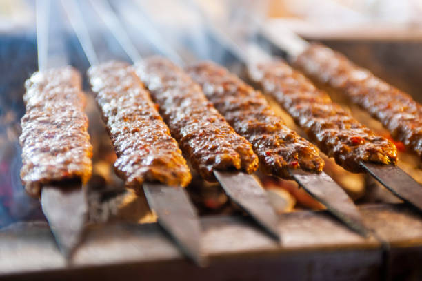 Cooking adana kebabs on bbq grill