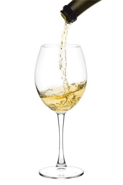 istock white wine poured from a bottle into wine glass on white backgro 1004229330