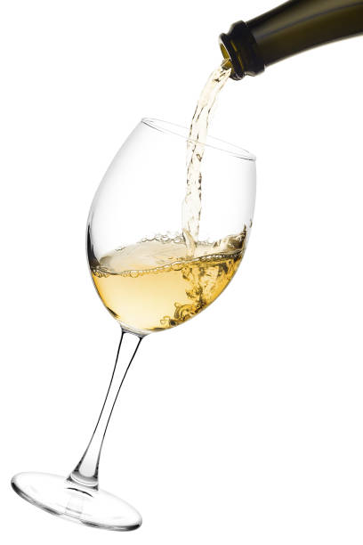 istock white wine poured from a bottle into wine glass on white backgro 1004229380