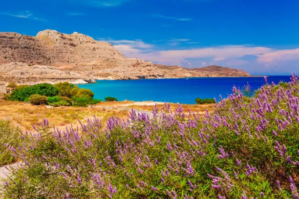 Sea skyview landscape photo near of Agia Agathi beach and Feraklos castle on Rhodes island, Dodecanese, Greece. Panorama with sand beach and clear blue water. Famous tourist destination in South Europe