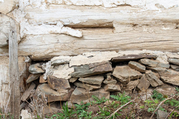 istock Old wooden wall on stone foundation. Rustic vintage house 1004230160
