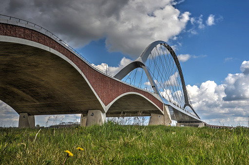 The concrete, brick and steel arches of new city bridge De Oversteek (The Crossing) across the river Waal near Nijmegen, the Netherlands