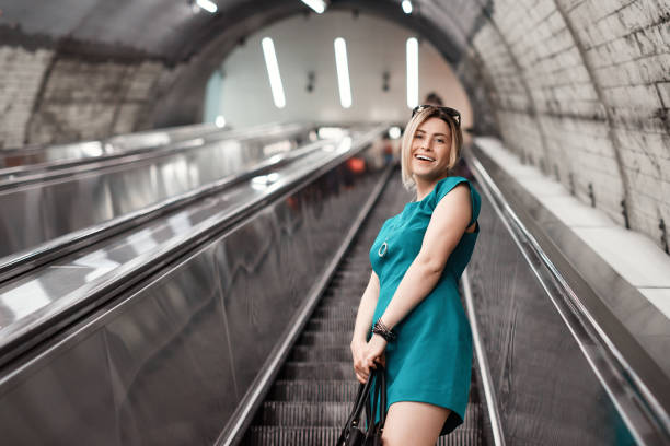istock woman on escalator in subway station 1004248742