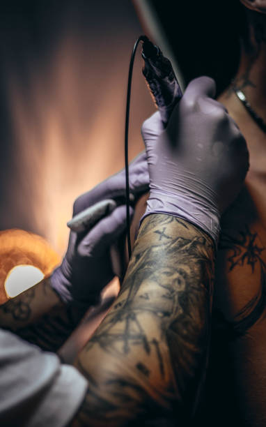 istock Tattoo master making tattoo on customer's shoulder 1004253756