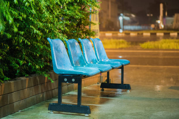 Blue chairs under the rain at night