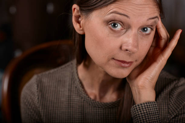 istock women on a chair feeling sick itself because of a headache 1004257726