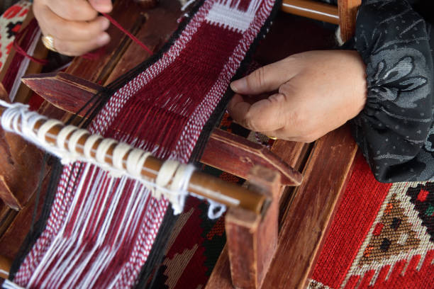 Hands of an arabian female weaver A senior arabian woman makes a traditional sadu weaving. Hands of a weaver close-up, focus on the hand. Qatar weaverbird photos stock pictures, royalty-free photos & images
