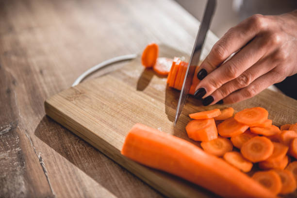 istock Woman cutting carrot 1004258898