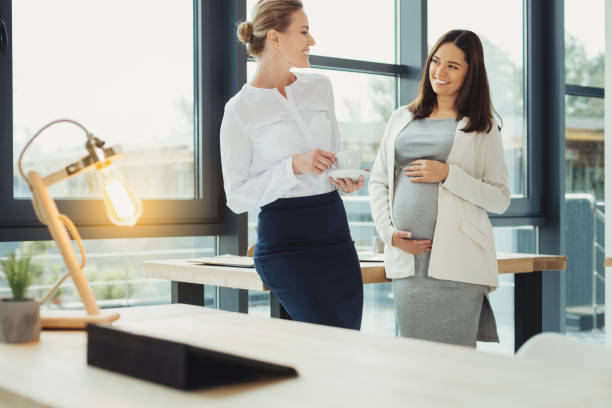 istock Friendly young colleagues standing together and laughing 1004266286